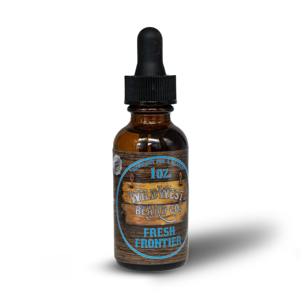 Bottle of Wild West Beard Co. Fresh Frontier beard oil with wooden label on a white background