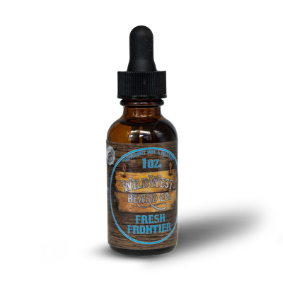Bottle of Wild West Beard Co. Fresh Frontier beard oil with wooden label on a white background