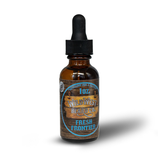 Bottle of Wild West Beard Co. Fresh Frontier beard oil with wooden label on a white background